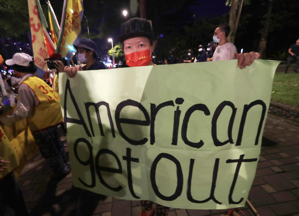 A protester holds a banner during a protest against the visit of United States House Speaker Nancy Pelosi, outside a hotel in Taipei, Taiwan, Tuesday, Aug 2, 2022. Pelosi arrived in Taiwan on Tuesday on a visit that could significantly escalate tensions with Beijing, which claims the self-ruled island as its own territory. (AP Photo/Chiang Ying-ying)