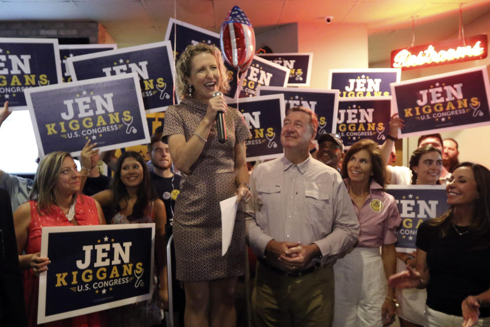 Virginia state Sen. Jen Kiggans, R-Virginia Beach, top, along with former Virginia Gov. George Allen, center right, speaks to supporters during an election party, Tuesday, June 21, 2022, in Virginia Beach, Va. Kiggans won a primary to face Democrat Elaine Luria in November's election. (AP Photo/Steve Helber)