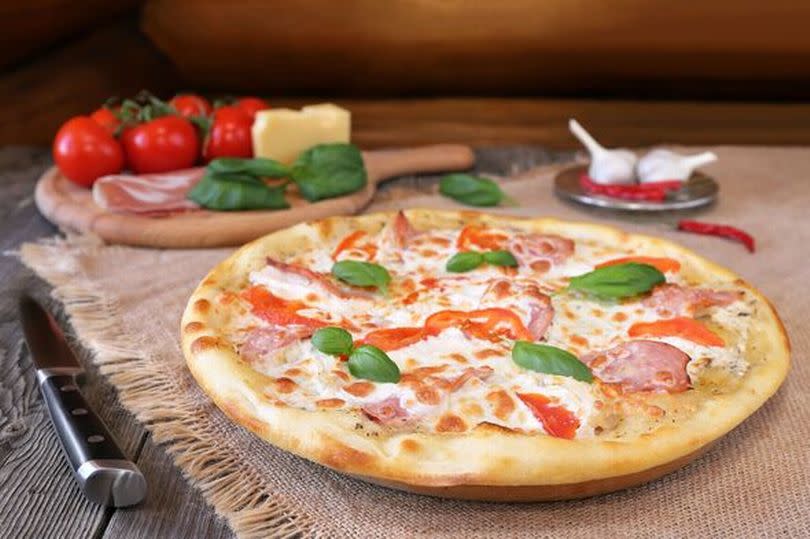 Pizza with ham and tomatoes