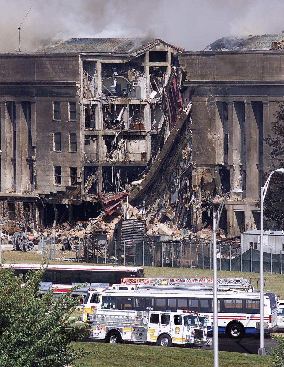 Emergency vehicles stand before a damaged wall of the Pentagon (AFP/Getty)