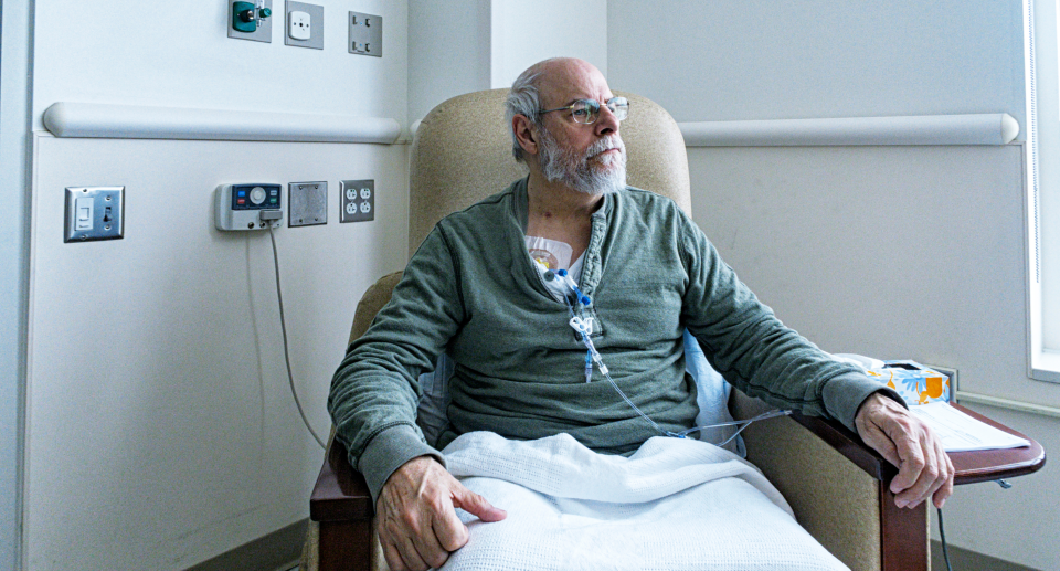 elderly man sitting in hospital chair with IVs and blanket over lap, map sitting in cancer ward in hospital receiving treatment, colon cancer, colorectal cancer, Are you at risk for colon cancer? Signs and symptoms you should never ignore (Photo via Getty)