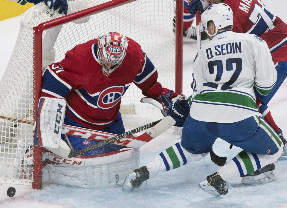 Montreal Canadiens goaltender Carey Price makes a save against Vancouver Canucks' Daniel Sedin during the second period of an NHL hockey game Thursday, Feb. 6, 2014, in Montreal. (AP Photo/The Canadian Press, Graham Hughes)