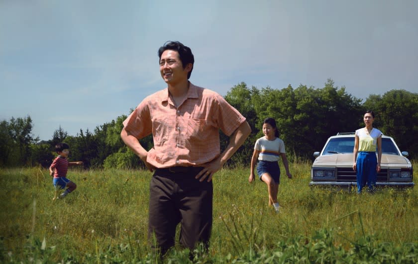 Steven Yeun standing in a scene from "Minari"