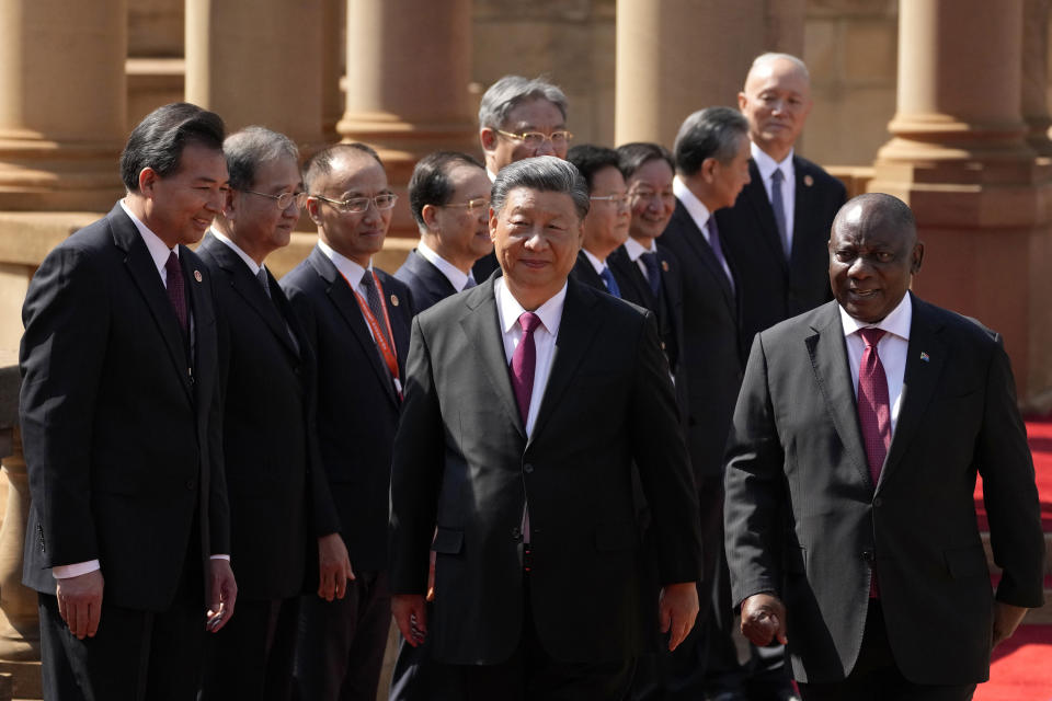 Chinese President Xi Jinping, centre, walks with South Africa's President Cyril Ramaphosa after introducing his cabinet members during a state visit at Union Building in Pretoria, South Africa, Tuesday, Aug. 22, 2023. Chinese President Xi Jinping has arrived for a state visit in South Africa where the two countries are expected to strengthen ties ahead of the BRICS summit starting in Johannesburg on Tuesday. (AP Photo/Themba Hadebe)