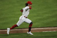 Cincinnati Reds' Jonathan India points to the dugout as he runs to first base after hitting a two-RBI single during the eighth inning of a baseball game against the Pittsburgh Pirates in Cincinnati, Monday, April 5, 2021. (AP Photo/Aaron Doster)