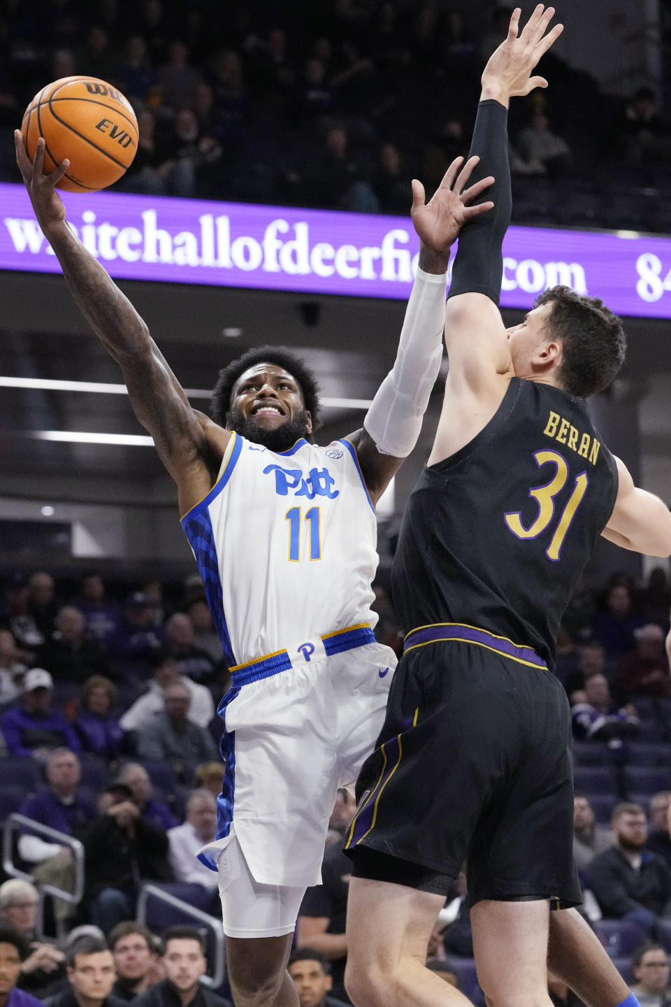 FILE - Pittsburgh guard Jamarius Burton, left, drives to the basket against Northwestern forward Robbie Beran during the first half of an NCAA college basketball game, Monday, Nov. 28, 2022, in Evanston, Ill. Pitt, picked to finish 14th in the ACC is off to a 4-1 start as the program searches for its first NCAA Tournament berth since 2016.(AP Photo/Nam Y. Huh, File