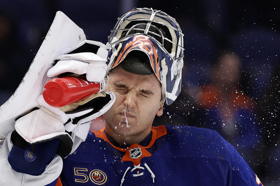 New York Islanders goaltender Ilya Sorokin sprays water onto his face after giving up a goal to St. Louis Blues defenseman Colton Parayko during the third period of an NHL hockey game Tuesday, Dec. 6, 2022, in Elmont, N.Y. The Blues won 7-4. (AP Photo/Adam Hunger)