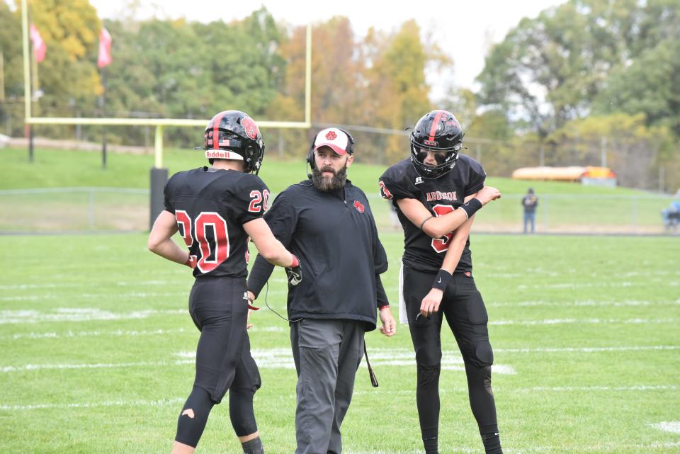 Addison's Ryan Worsham (20) and Dylan Sawdey (3) talk with head coach Josh Lindeman during the 2021 Cascades-Big 8 crossover game.