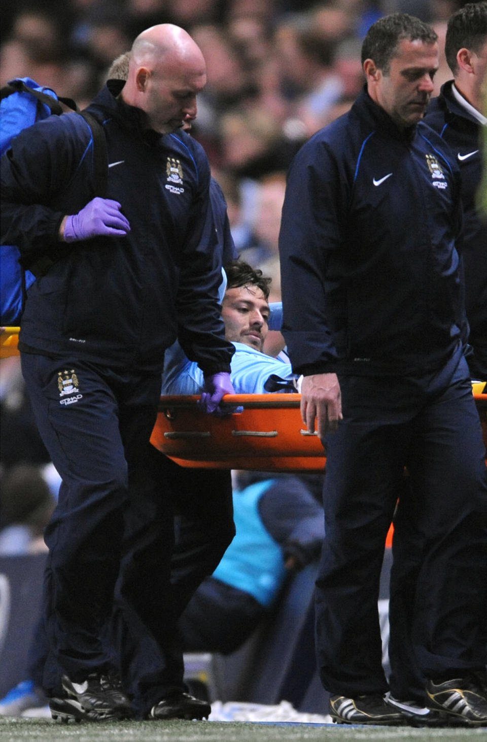 Manchester City's David Silva, center, is stretchered from the pitch during the English Premier League soccer match against West Bromwich Albion at the Etihad Stadium, Manchester, England, Monday April 21, 2014. (AP Photo/Rui Vieira)