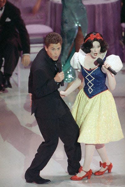 In this March 30, 1989, file photo, actor Rob Lowe croons a tune to Snow White during the opening number for the 61st Academy Awards.