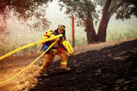 A firefighter battles the Glass Fire burning in a Calistoga, Calif., vineyard Thursday, Oct. 1, 2020. (AP Photo/Noah Berger)