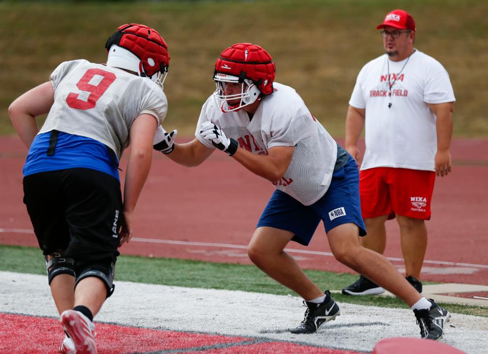 Nixa High School freshman Jackson Cantwell (right) runs drills during football practice on Tuesday, July 12, 2022. Cantwell is 6-foot-8 and a multi-sport athlete and also scored a 33 on the ACT.