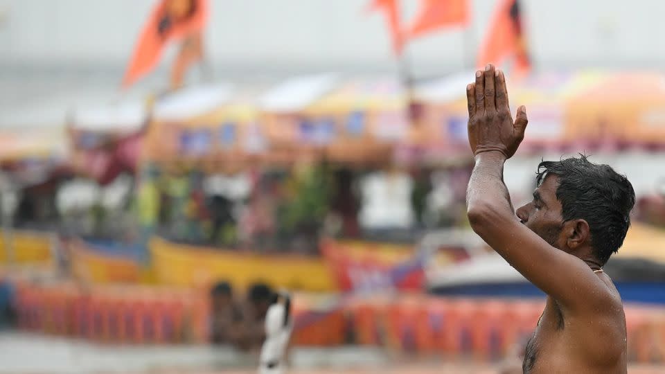 A man prays on the banks of Sarayu River on the occasion of Ram temple's consecration ceremony in Ayodhya on January 22, 2024. - Money Sharma/AFP/Getty Images