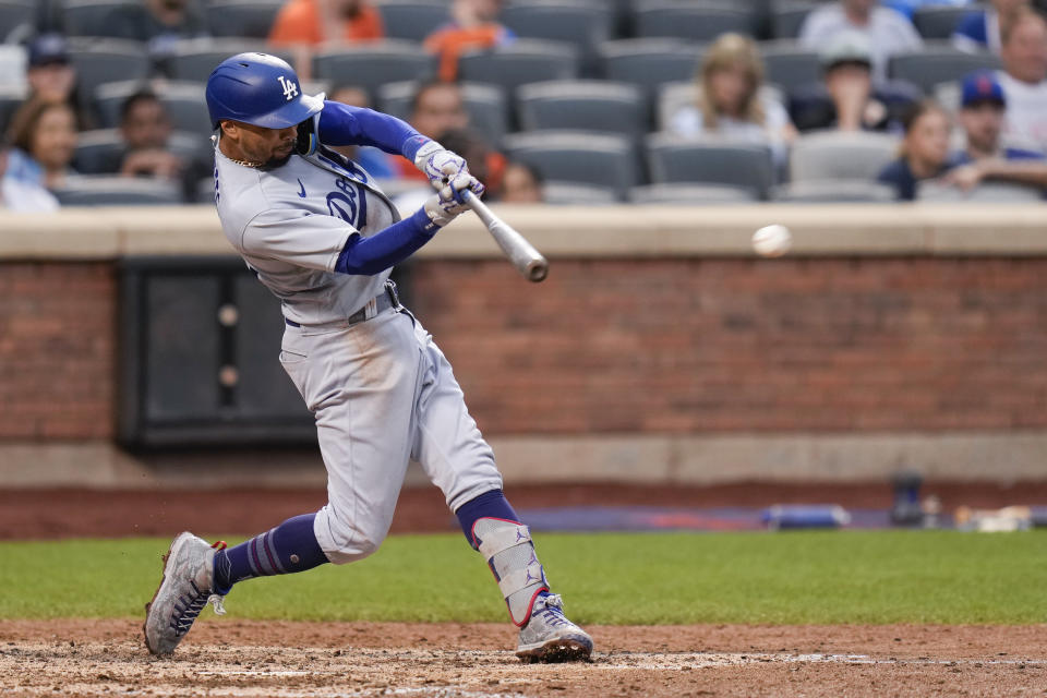 Los Angeles Dodgers' Mookie Betts hits an RBI single during the eighth inning of the baseball game against the New York Mets at Citi Field, Sunday, July 16, 2023, in New York. (AP Photo/Seth Wenig)