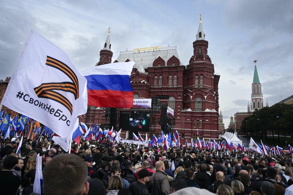 Russians hold state flags and flags with the letter Z, a symbol of the Russian military, with the hashtag ‘we don’t abandon our own’ at a demonstration in Moscow in September 2022 on the eve of referendums in four Russian-held regions of Ukraine. (AP Photo/Alexander Zemlianichenko, File)