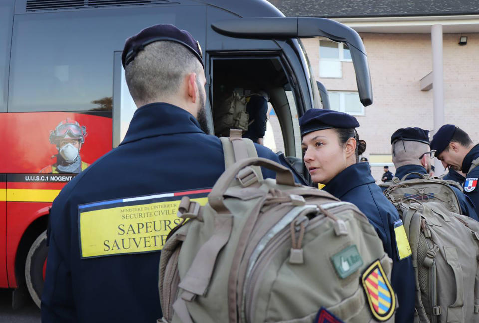 This photo provided Tuesday Feb.7, 2023 by the French Interior Ministry shows rescue workers boarding a bus for the Charles de Gaulle airport, north of Paris, Monday, Feb.6, 2023 in Nogent-le-Rotrou, central France. Countries around the world dispatched teams to assist in the rescue efforts, and Turkey's disaster management agency said more than 24,400 emergency personnel were now on the ground. But with such a wide swath of territory hit by Monday's earthquake and nearly 6,000 buildings confirmed to have collapsed in Turkey alone, their efforts were spread thin. (Ministere de l'Interieur via AP)