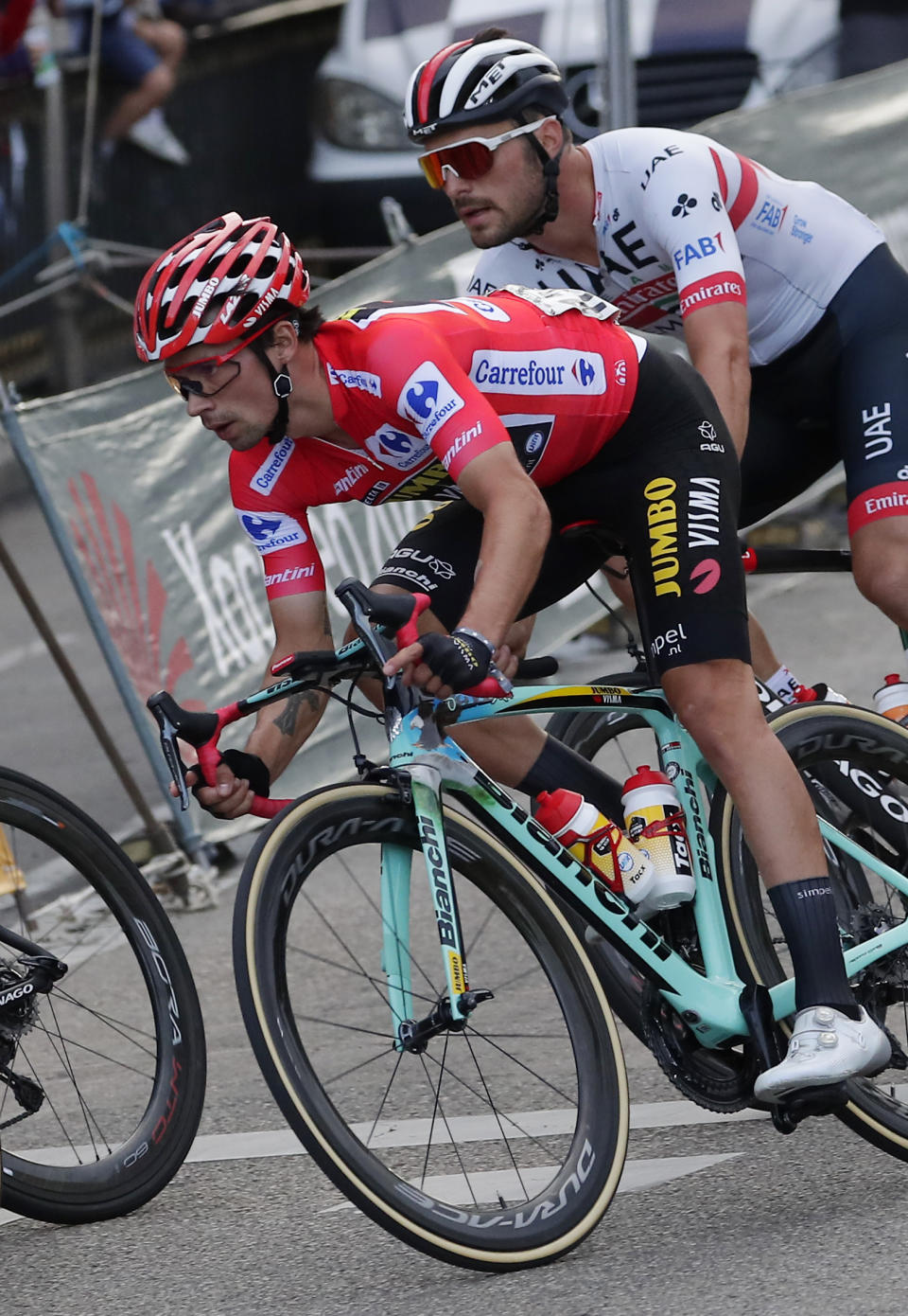 Race leader Primoz Roglic, left, rides with the pack in the Spanish capital during the La Vuelta cycling race in Madrid, Spain, Sunday, Sept. 15, 2019. (AP Photo/Manu Fernandez)