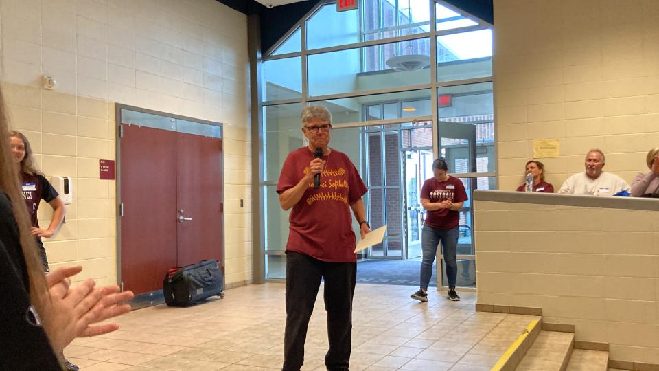 Morenci softball head coach Kay Johnson takes the mic to speak after being surprised by current and former student-athletes for her 50 years of leading the softball program.
