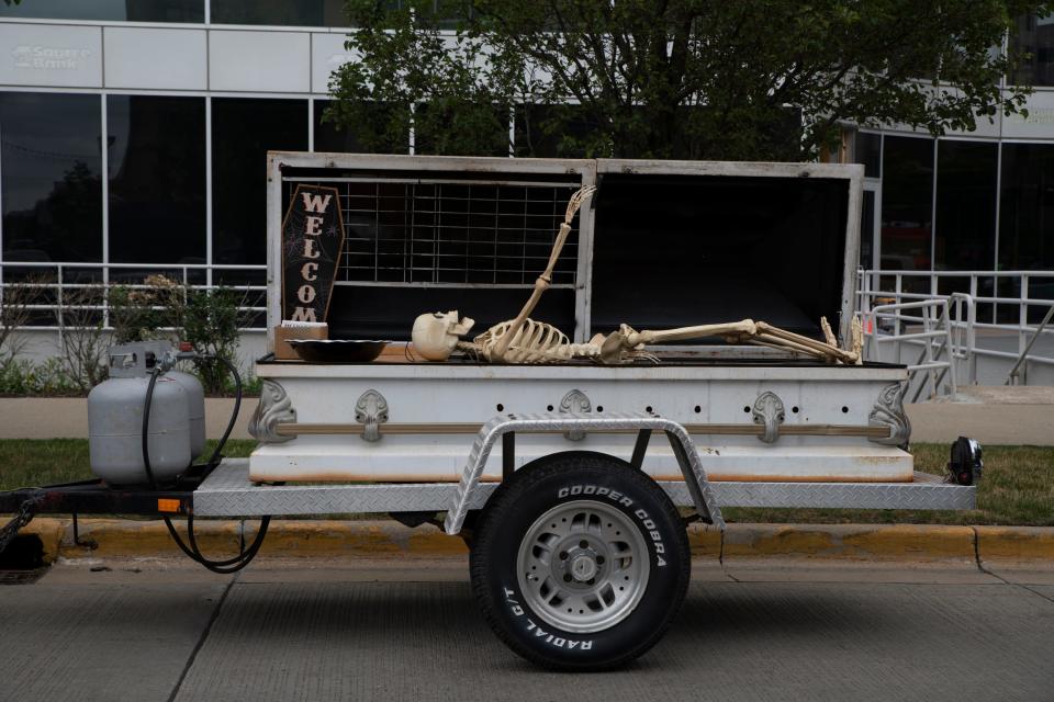 A skeleton prop and candy bowl are put in a trailer from a 1980s funeral Hearse at the Back To The Bricks car show in South Bend on June 12, 2023.