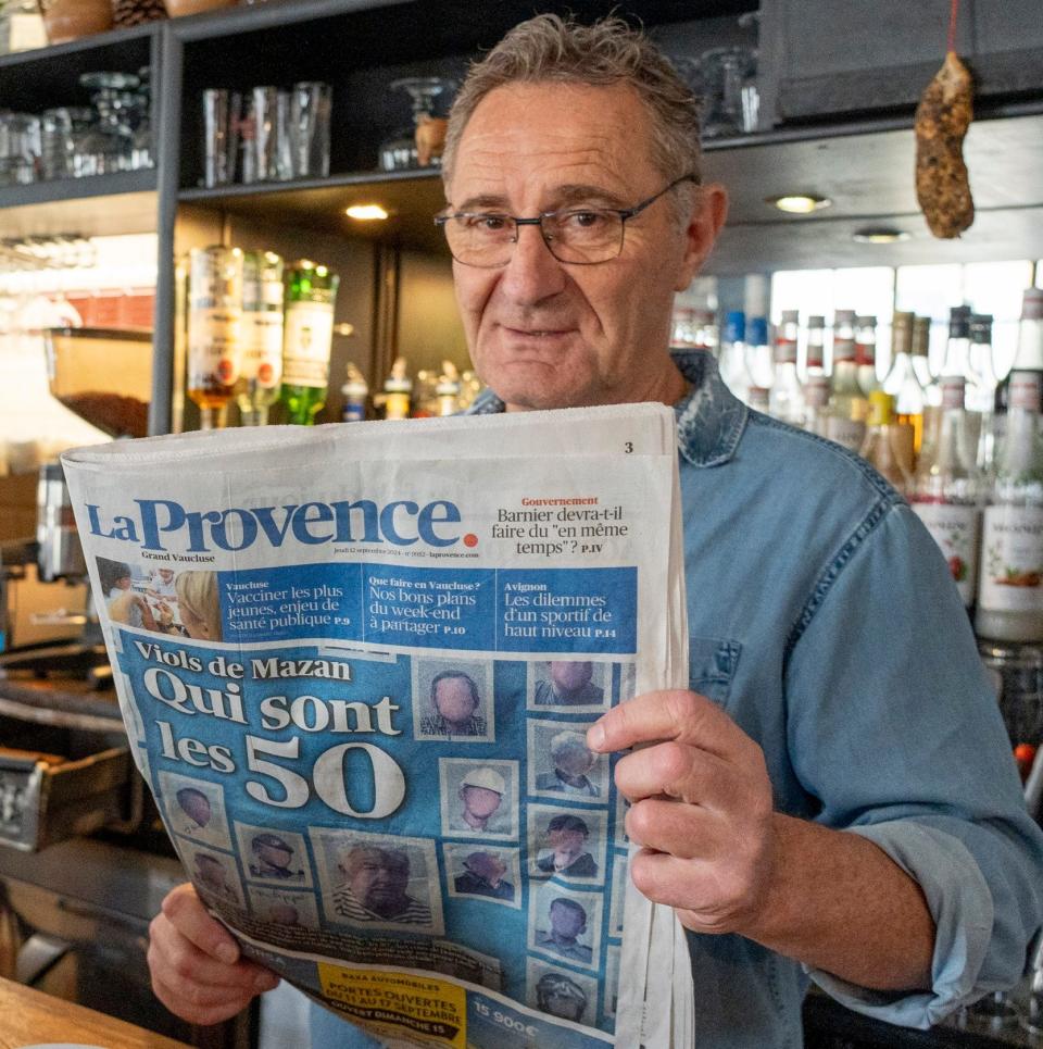 Mr. Flagon holds a newspaper that reports on the trial on the front page