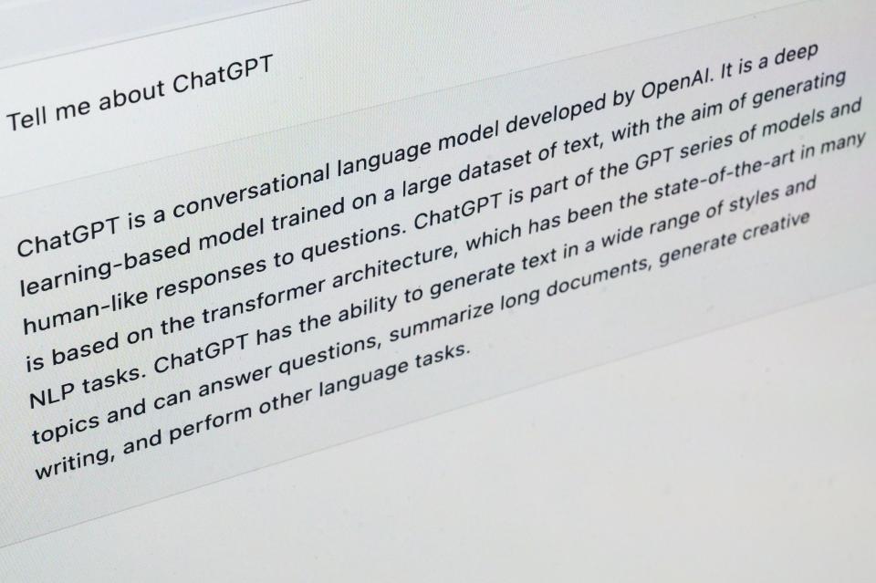 In this photo illustration, ChatGPT answers the query, "tell me about ChatGPT" on a laptop screen.