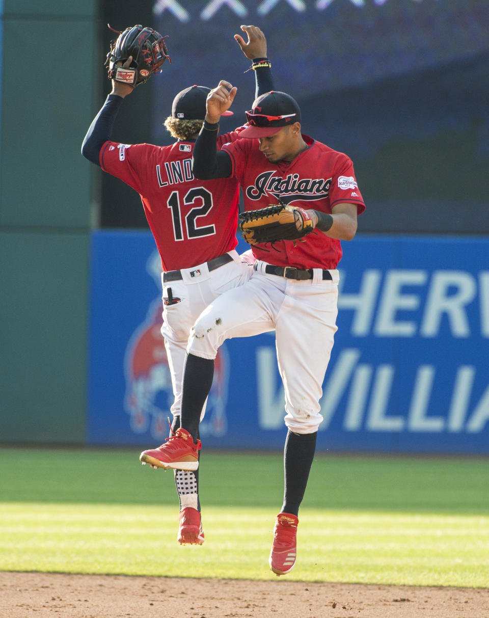 Cleveland Indians' Oscar Mercado celebrates with Francisco Lindor after the Indians' 5-1 win over the Texas Rangers in the second game of a baseball doubleheader in Cleveland, Wednesday, Aug. 7, 2019. It was a diving catch in center field by Mercado of a Danny Santana line drive for the third out that preserved the win. (AP Photo/Phil Long)