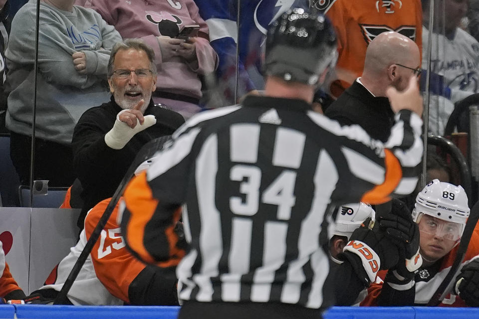 Philadelphia Flyers head coach John Tortorella, left, yells at referee Brad Meier (34) after being kicked out the game against the Tampa Bay Lightning during the first period of an NHL hockey game Saturday, March 9, 2024, in Tampa, Fla. (AP Photo/Chris O'Meara)