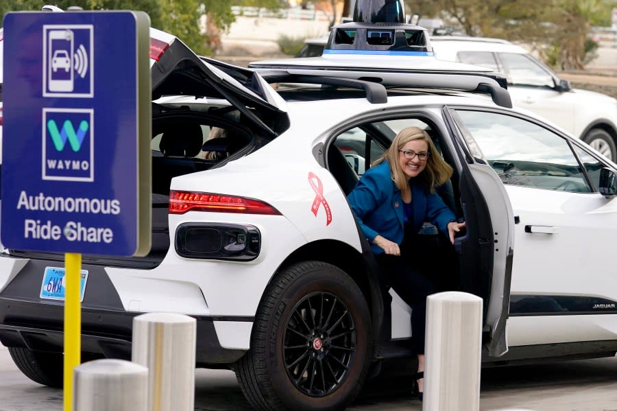 FILE - Phoenix Mayor Kate Gallego arrives in a Waymo self-driving vehicle on Dec. 16, 2022, at the Sky Harbor International Airport Sky Train facility in Phoenix. Self-driving car pioneer Waymo announced Thursday, May 4, 2023, that its robotaxis will be able to carry passengers through most of the Phoenix area for the first time. (AP Photo/Matt York, File)