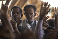 Rohingya refugees watch others protesting against the repatriation process at Unchiprang refugee camp near Cox's Bazar, in Bangladesh, Thursday, Nov. 15, 2018. The head of Bangladesh's refugee commission said plans to begin a voluntary repatriation of Rohingya Muslim refugees to their native Myanmar on Thursday were scrapped after officials were unable to find anyone who wanted to return. (AP Photo/Dar Yasin)