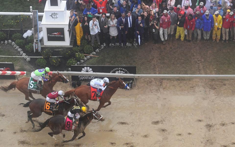 Justify with Mike Smith atop wins the 143rd Preakness Stakes in the mud - FR67404 AP
