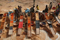 Artisanal miners sluice for gold by pouring water through gravel at an unlicensed mine near the city of Doropo, Ivory Coast, February 13, 2018. REUTERS/Luc Gnago