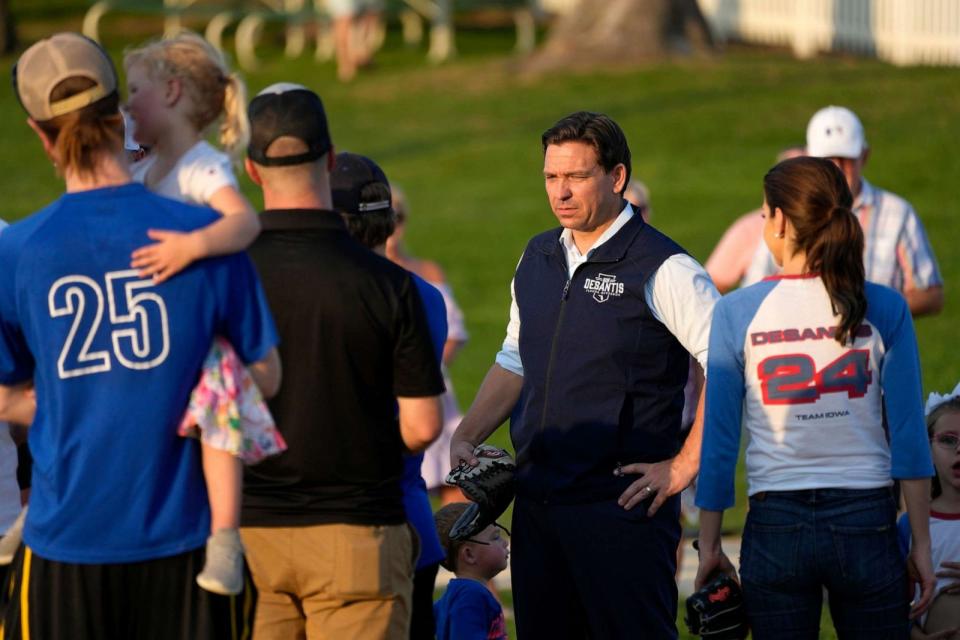 PHOTO: Republican presidential candidate Florida Gov. Ron DeSantis talks with local players during a campaign stop at the Field of Dreams movie site, Aug. 24, 2023, in Dyersville, Iowa. (Charlie Neibergall/AP)