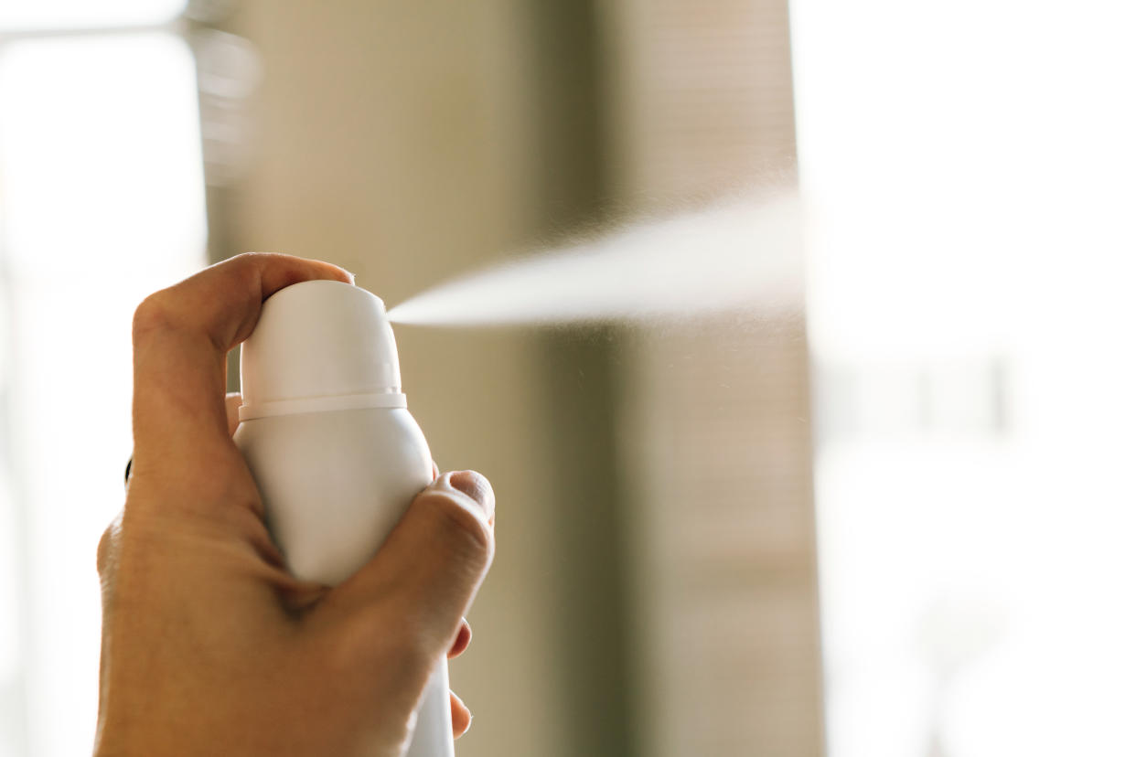 A can of aerosol deodorant being sprayed.