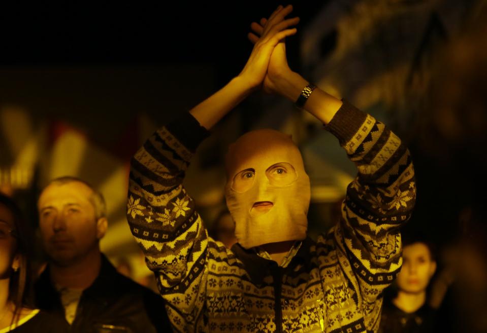 A masked spectator reacts during the concert organized to support jailed Pussy Riot musicians in St. Petersburg, Russia, Sunday, Sept. 9, 2012. A Moscow judge has sentenced each of three members of the provocative punk band Pussy Riot to two years in prison on hooliganism charges following a trial that has drawn international outrage as an emblem of Russia's intolerance to dissent. (AP Photo/Dmitry Lovetsky)