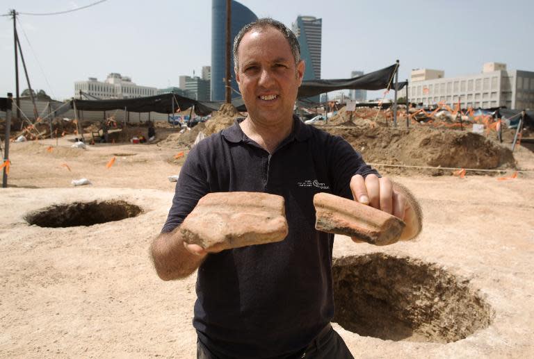 Diego Barkan shows fragments of 5,000 year-old ancient pottery vessels believed to have been used to prepare beer