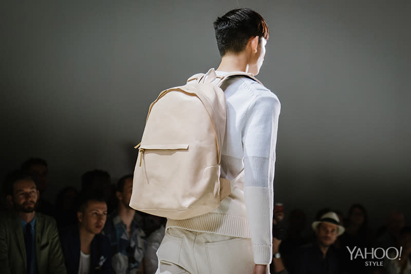 A beige backpack keeps the neutrality of this look in tact.