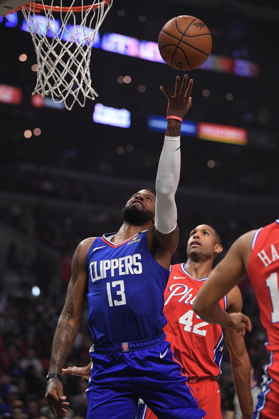 Los Angeles Clippers guard Paul George, left, shoots as Philadelphia 76ers forward Al Horford defends during the first half of an NBA basketball game Sunday, Mar. 1, 2020, in Los Angeles. (AP Photo/Mark J. Terrill)