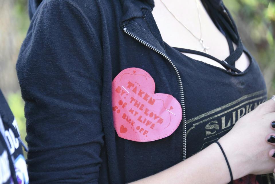 <p>A student wears a Valentine’s pin as she leaves Marjory Stoneman Douglas High School in Parkland, Florida, a city about 50 miles (80 kilometers) north of Miami on Feb. 14, 2018 following a school shooting.(Photo: Michele Eve Sandberg/AFP/Getty Images) </p>