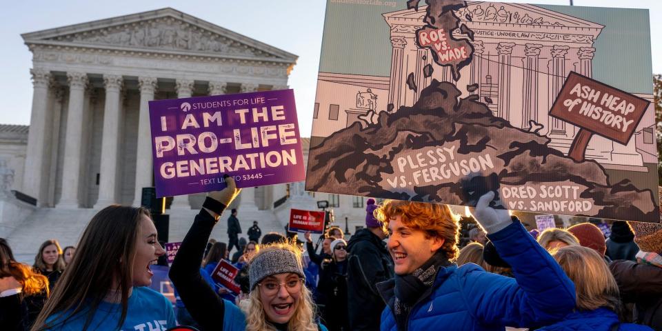 Anti-abortion protesters wear shirts that read "I am the Pro-Life Generation" as they demonstrate in front of the U.S. Supreme Court, Wednesday, Dec. 1, 2021, in Washington,