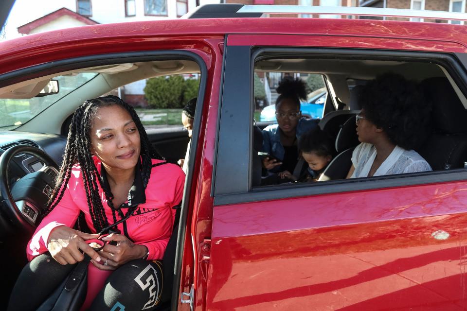 Angel Thompson, left, watches from her car with her children Heaven Thompson, Christian Braggs, 2, and Skyye Thompson, 13  as her son Cedric Robinson, 11, of the Motor City Ravens youth baseball team (not in the photo) practices at Calcara Park in Detroit on Wednesday, April 13, 2023.