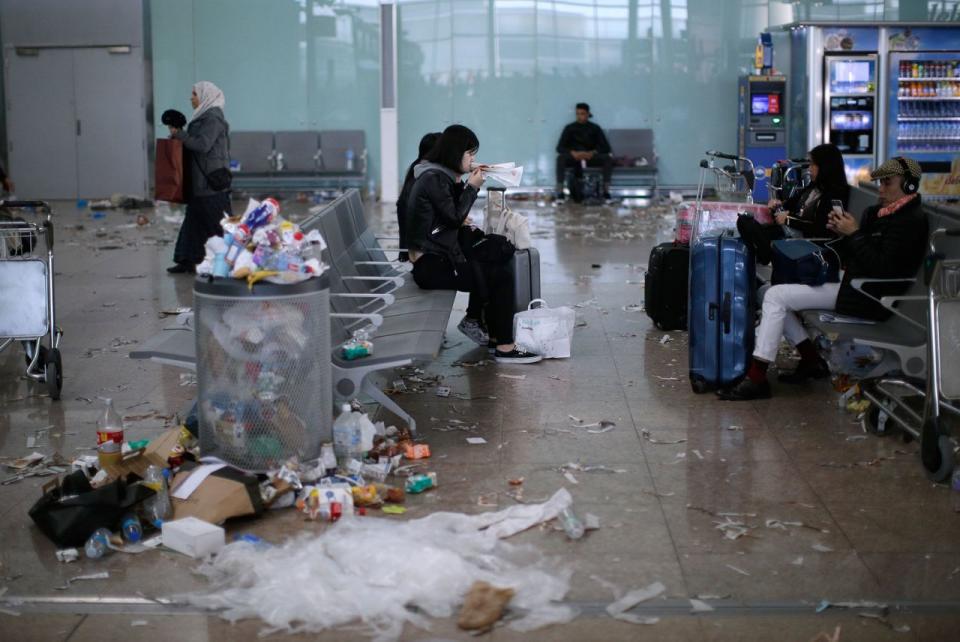 <p>Passanten auf einem Flughafen sind von Müllbergen umgeben, nachdem die Reinigungskräfte auf dem Barcelona Airport im spanischen El Prat de Llobregat bereits den vierten Tag streiken. (Bild: AP Photo/Manu Fernandez) </p>