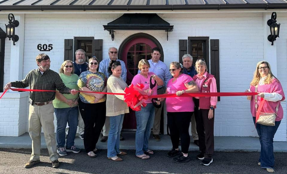 Shanda Williams and Brandy Sutton, along with representatives from the Jefferson County Chamber of Commerce, cut a ribbon officially opening their new shop Love Brews in downtown Louisville, GA.