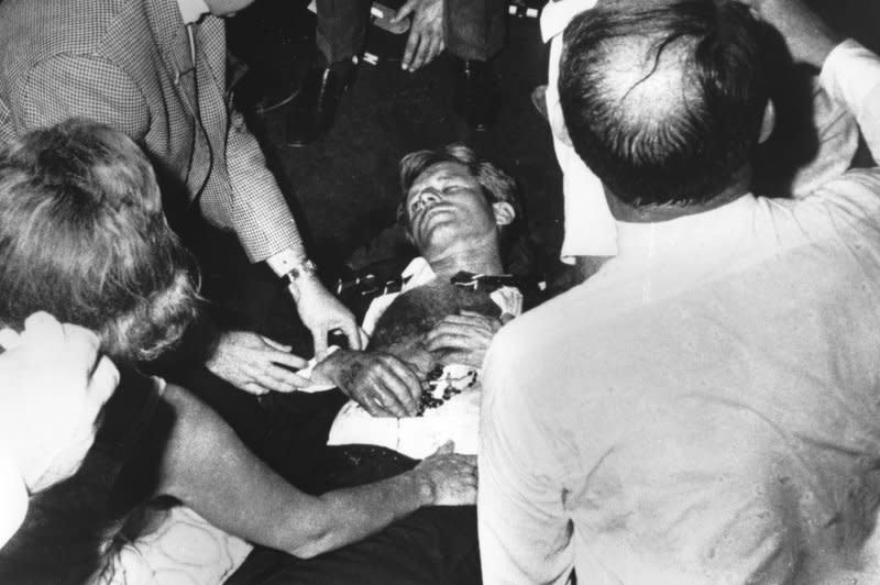 Clutching his rosary beads, Sen. Robert F. Kennedy lies injured on the floor of the Ambassador Hotel after being shot by assailant Sirhan Sirhan on June 5, 1968 following his victory speech in the California primary election. Kennedy's wife, Ethel Kennedy, is at lower left. UPI File Photo