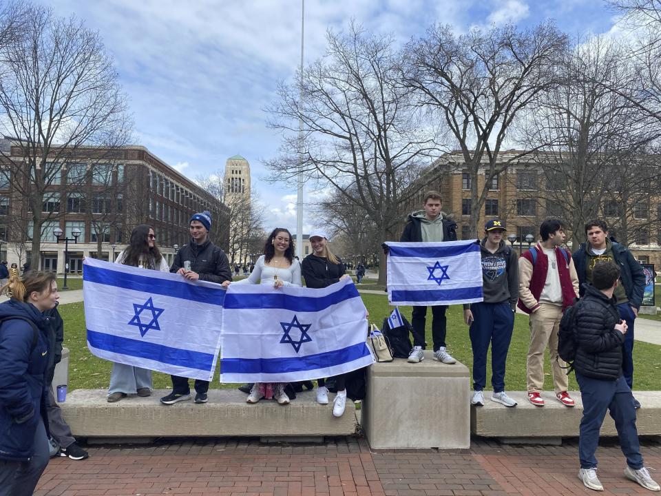 A group of demonstrators on the University of Michigan Diag Thursday, April 4, 2024, in Ann Arbor counterprotests as another group urges the university not to adopt a new policy meant to reduce disruptive demonstrations on campus. A University of Michigan proposal aimed at deterring disruptions on its Ann Arbor campus after anti-Israel protesters interrupted an honors convocation is sparking backlash from free speech advocates (Zena Issa/Michigan Public Radio via AP)