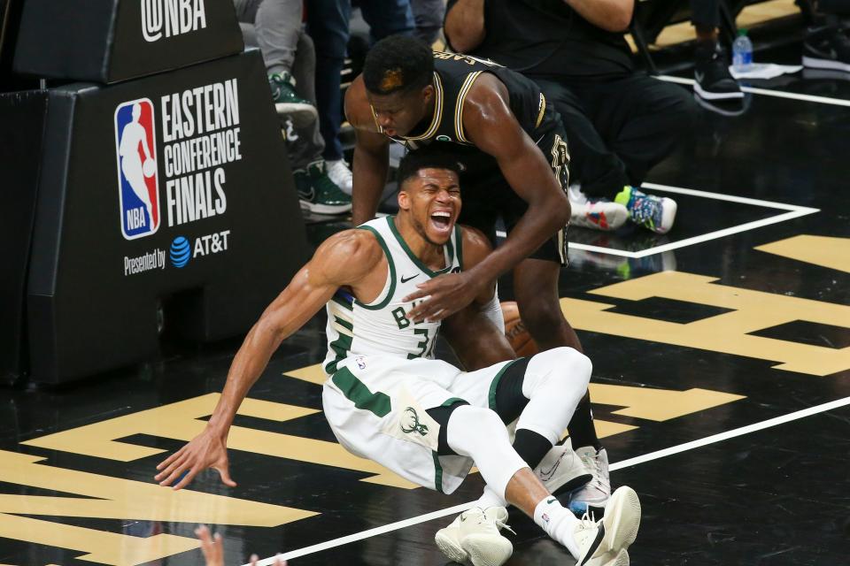 East finals: Bucks forward Giannis Antetokounmpo crashes to the floor in agony with a left knee injury during the third quarter of Game 4. Antetokounmpo left the game and did not return.