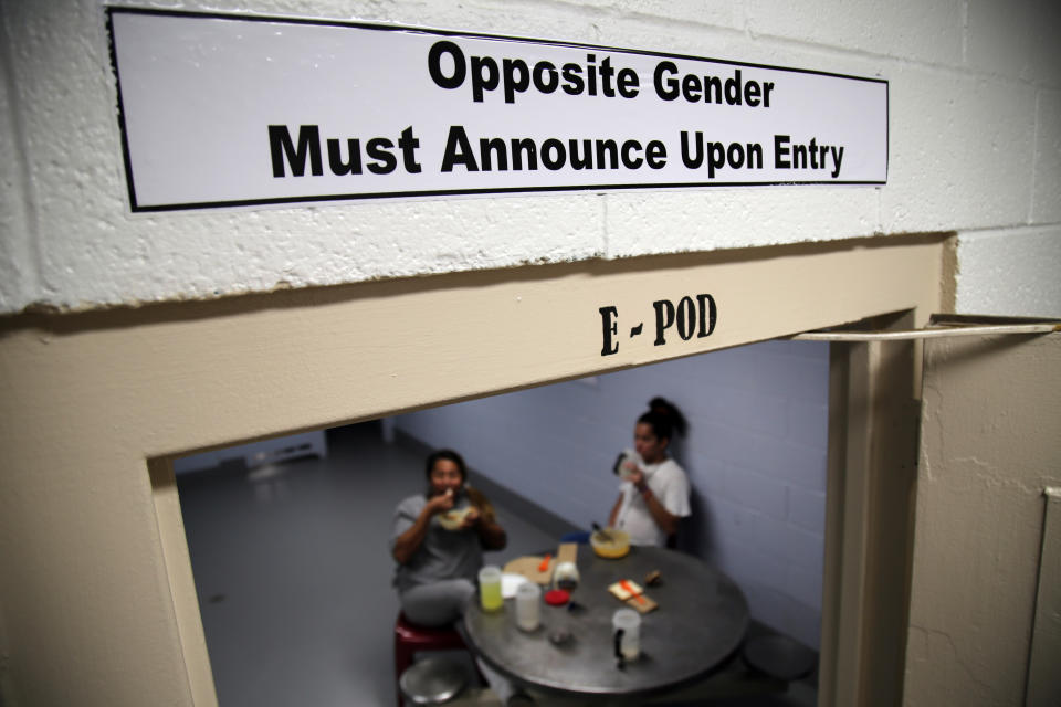 This June 6, 2019 image provided by U.S. Immigration and Customs Enforcement shows one of the signs over the doorways within the dedicated unit for transgender migrants in the Cibola County Correctional Center in Milan, N.M. (Ron Rogers/U.S. Immigration and Customs Enforcement via AP)