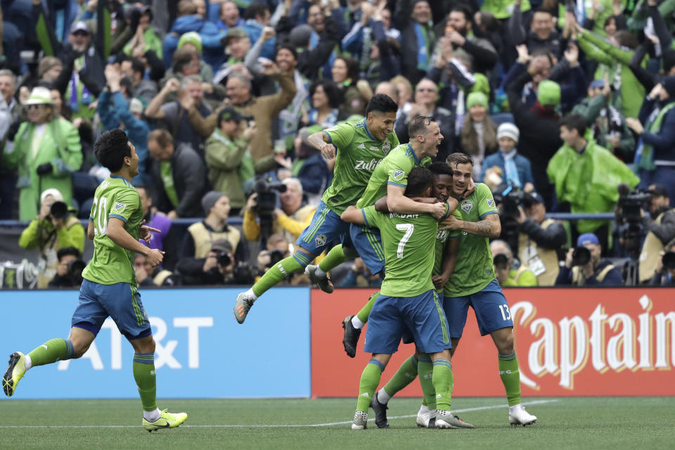 Seattle Sounders' Kelvin Leerdam, second right, is mobbed by teammates after he scored against Toronto FC during the second half of the MLS Cup championship soccer match Sunday, Nov. 10, 2019, in Seattle. The Sounders won 3-1. (AP Photo/Elaine Thompson)