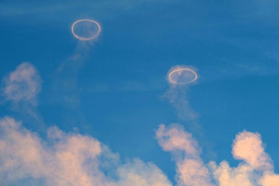 <p>Salvatore Cavalli/SOPA Images/LightRocket via Getty </p> Two gas rings in the sky by Mount Etna