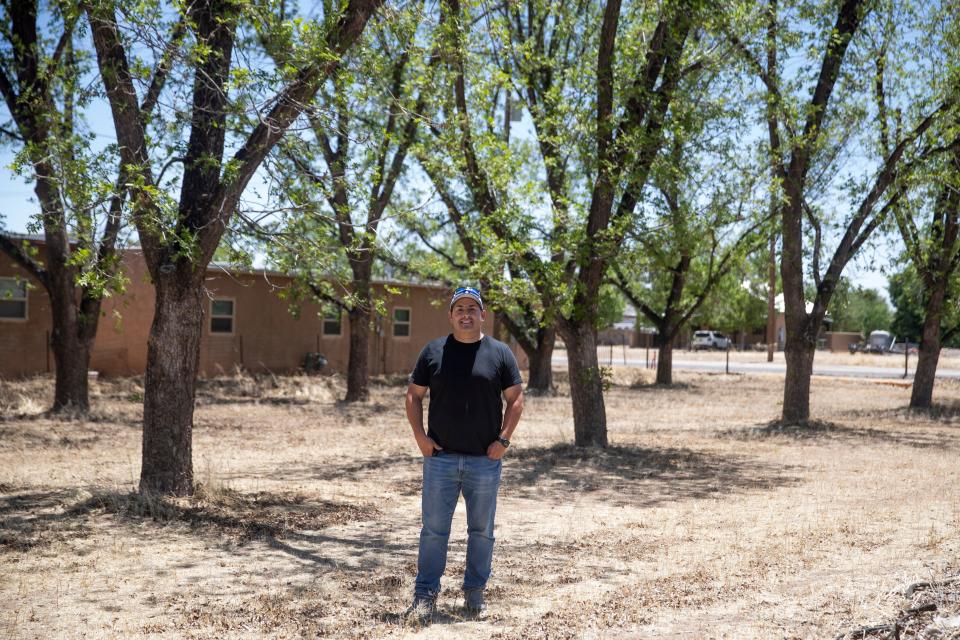 Anthony Lucero stands in front of his family's 14 pecan trees in Mesilla on Thursday, May 19, 2022. His family has owned the land since before New Mexico was a state.