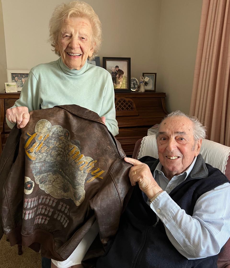 Mary and John Stellitano hold John's jacket used during his service in World War II.